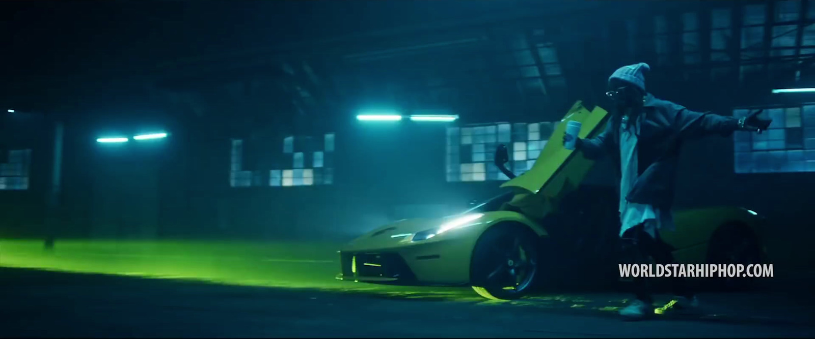 a man standing next to a sports car