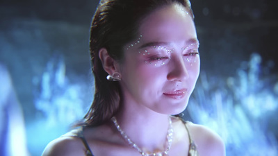 a woman with a pearl necklace and pearls on her face