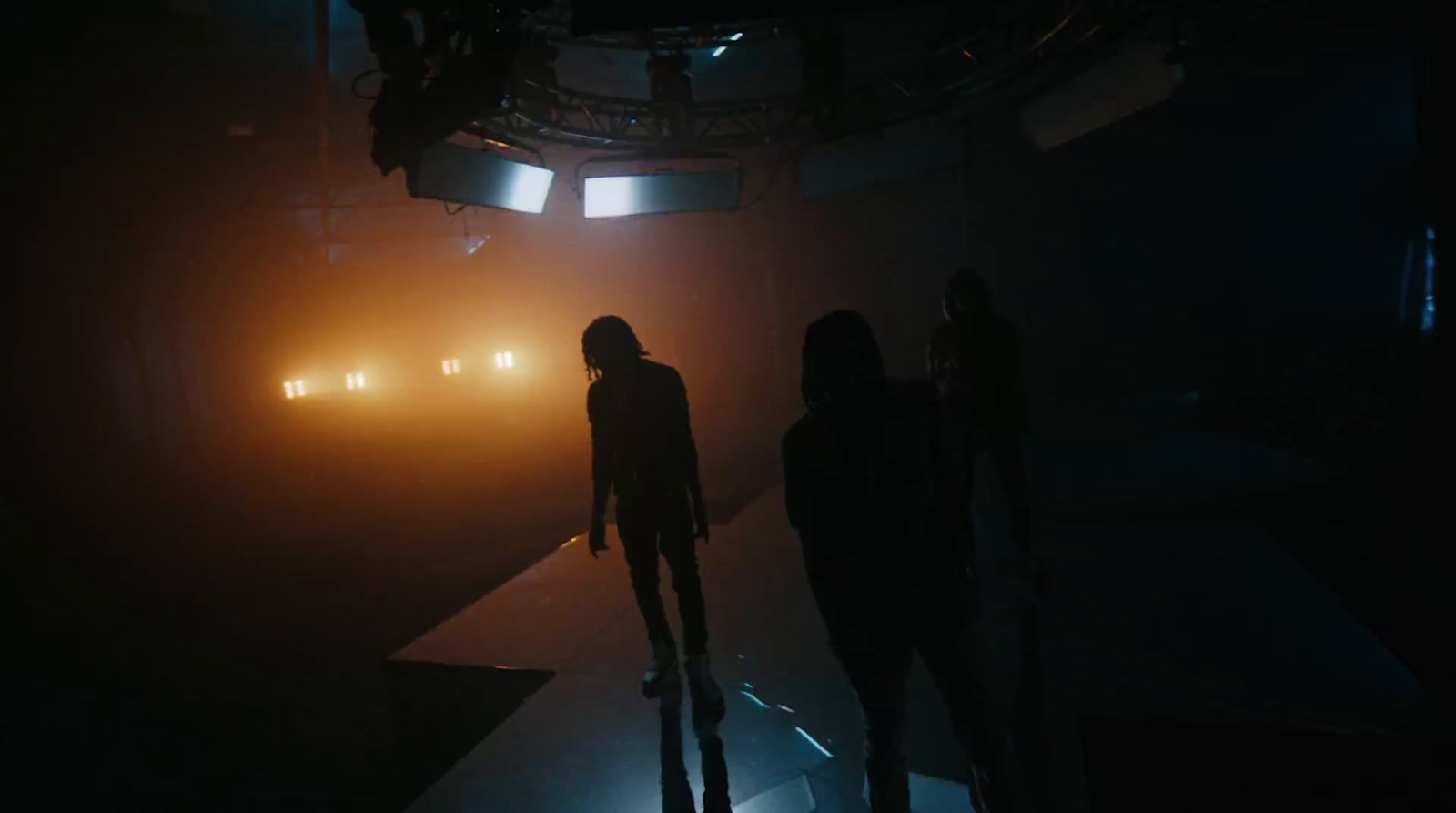 a group of people standing in a dark room