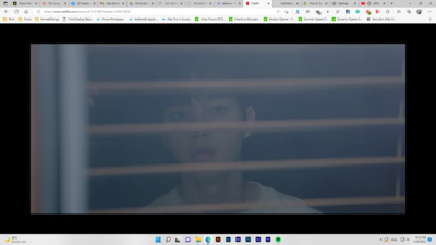 a screen shot of a man looking out of a window