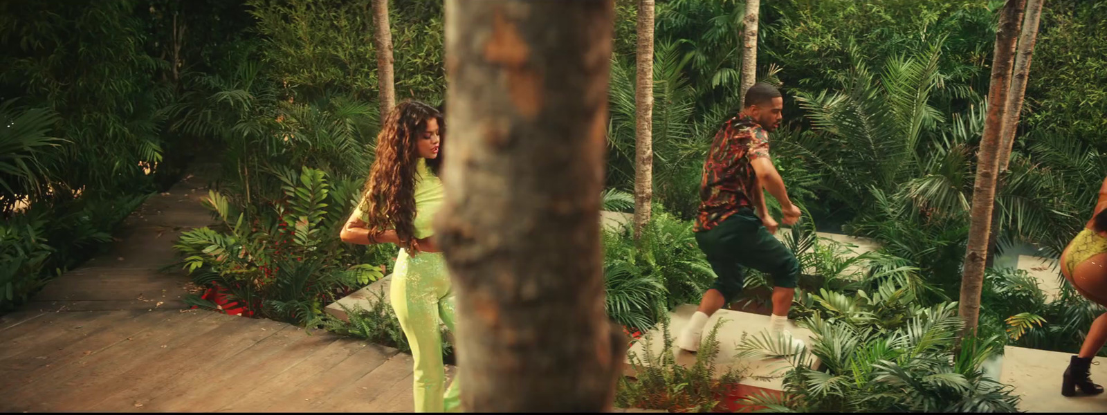 a man and a woman walking through a forest