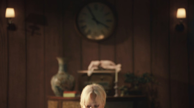 a little girl sitting on a chair in a room