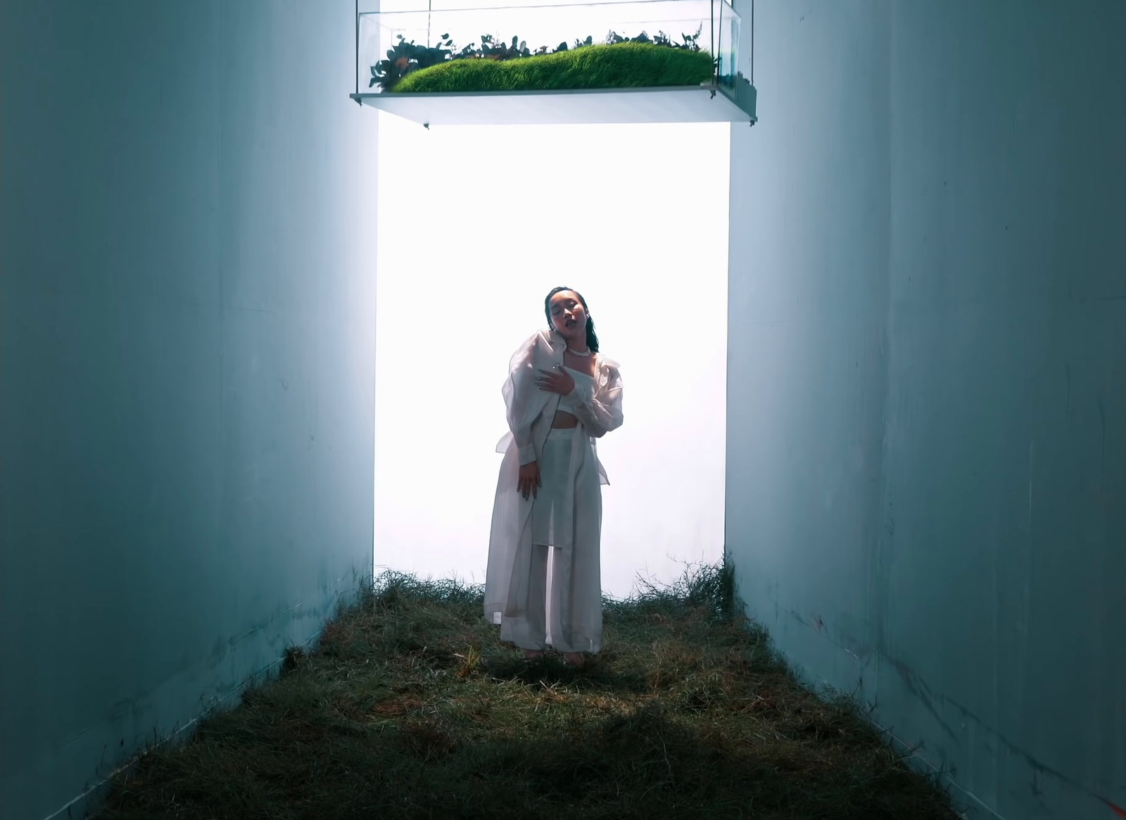 a woman in a white robe standing in a room