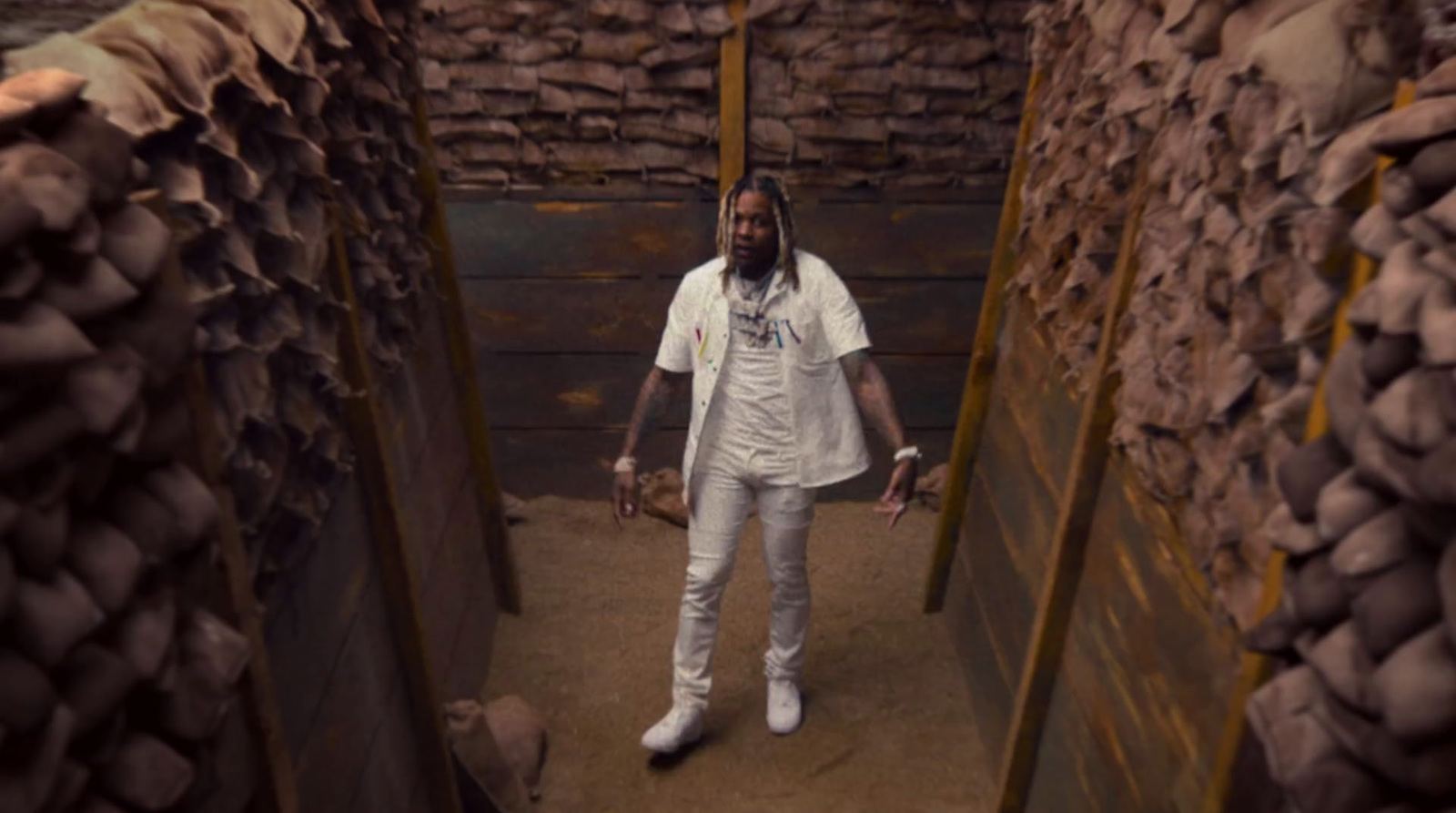 a man standing in a room filled with bricks