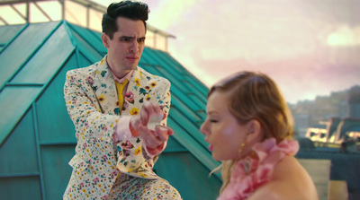 a man in a white suit and a woman in a pink dress