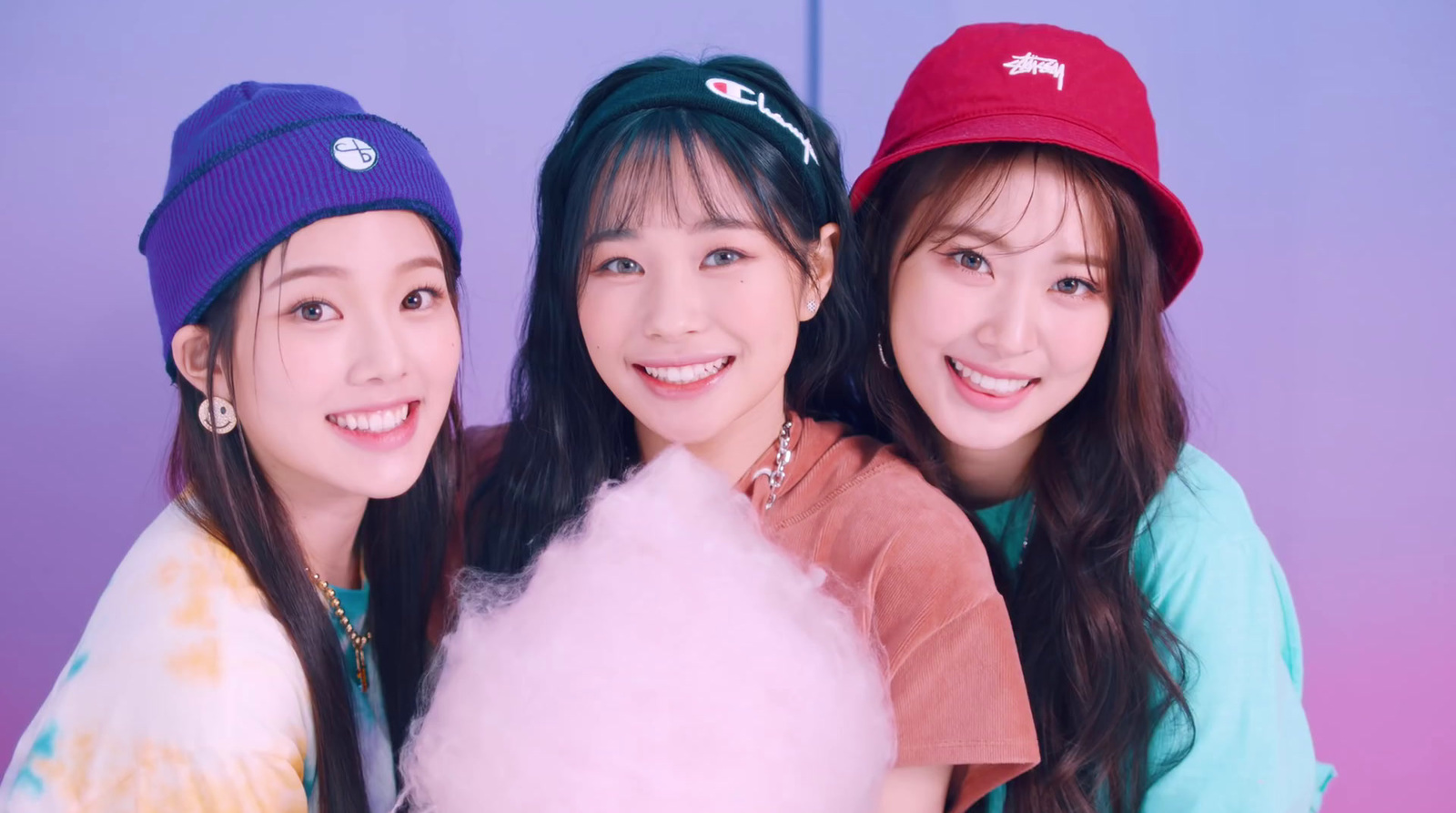 three young women posing for a picture with a cotton candy