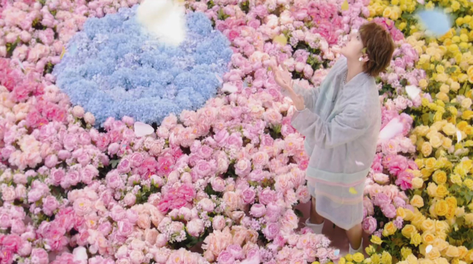 a woman standing in a field of flowers