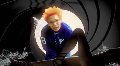 a man with orange hair sitting in a tunnel