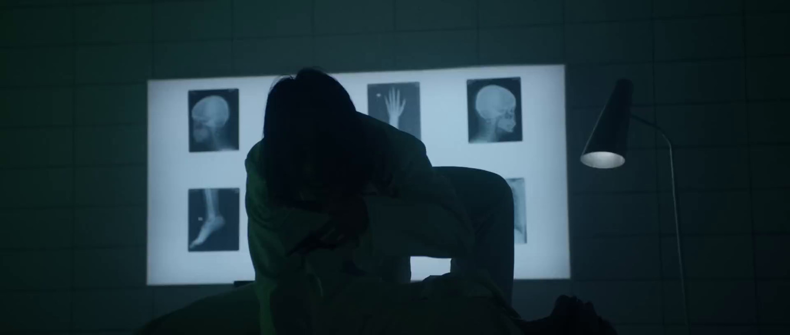 a person sitting in a chair in a dark room