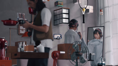 a woman standing in a kitchen next to a man