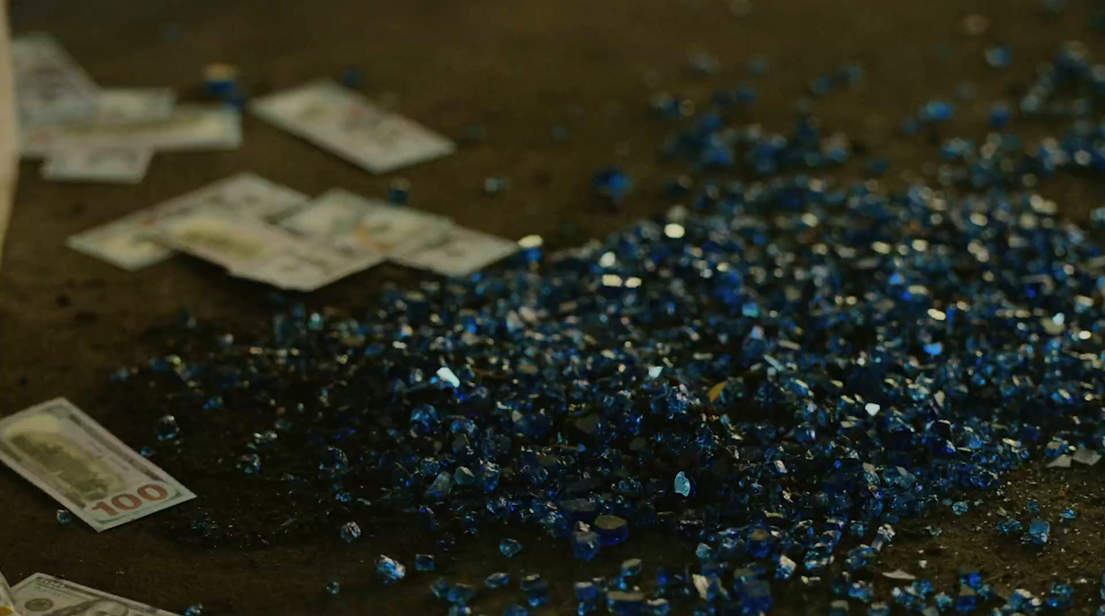 a pile of blue confetti sitting on top of a table