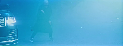 a woman standing next to a parked car under water