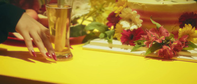 a woman is holding a glass of beer