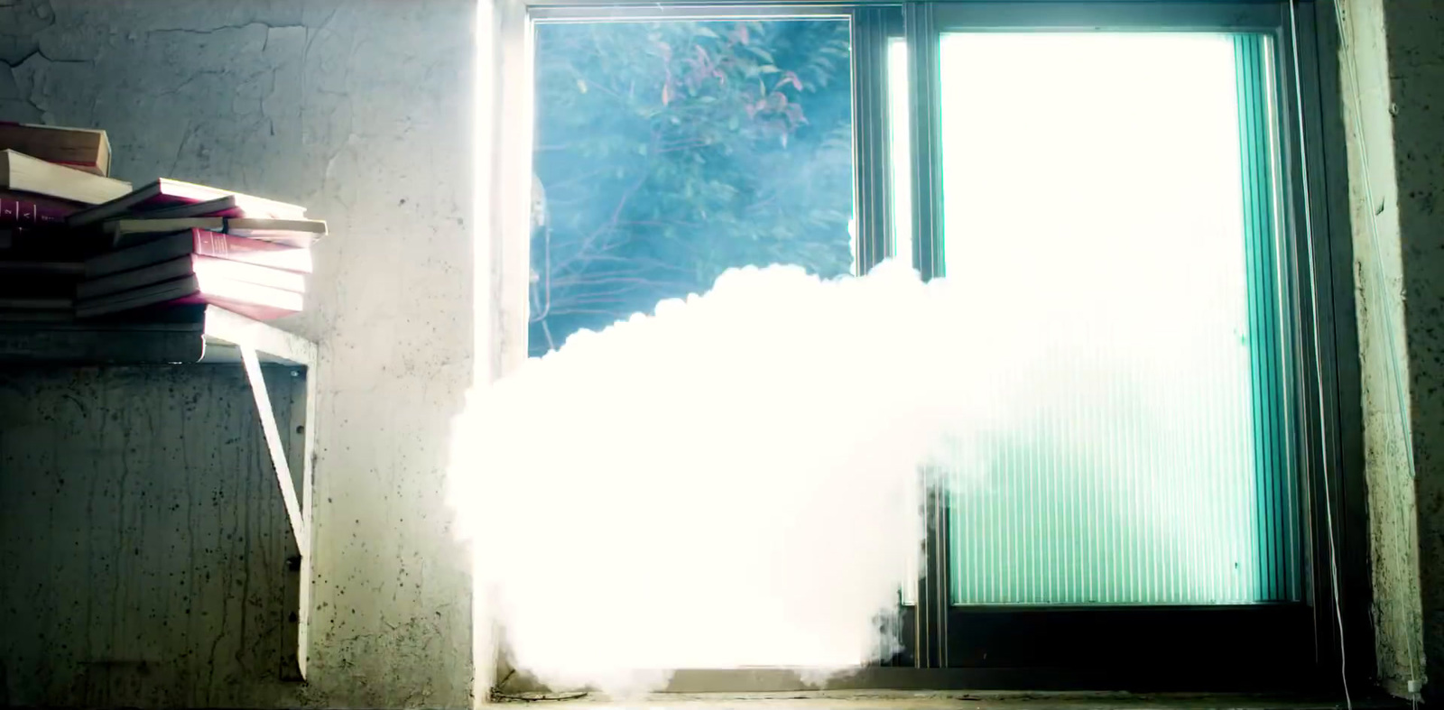 a cloud of smoke is coming out of a window