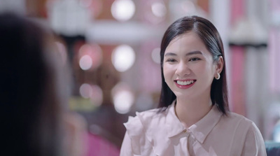 a woman in a white shirt and tie smiling