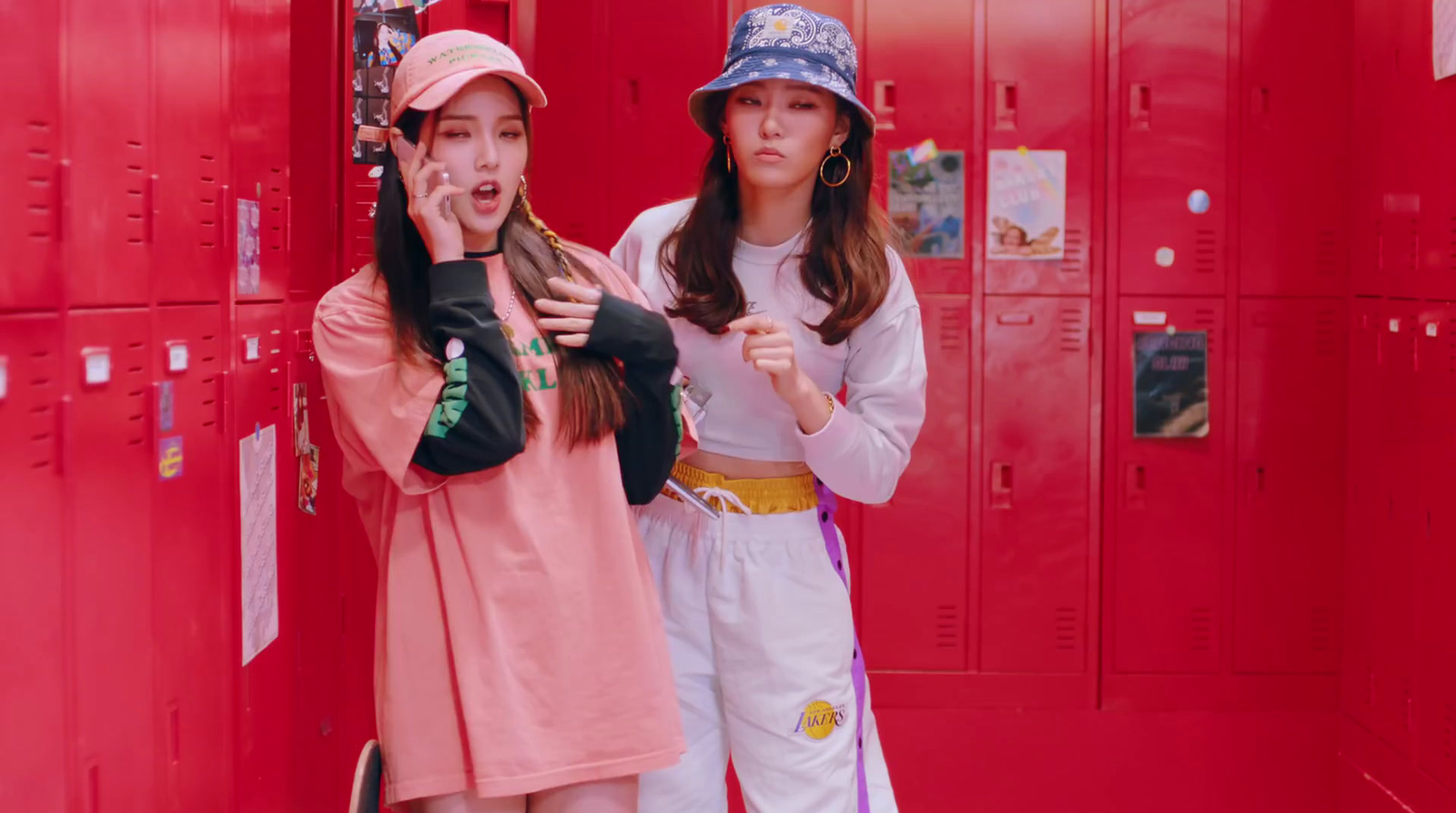 two young women standing in front of lockers