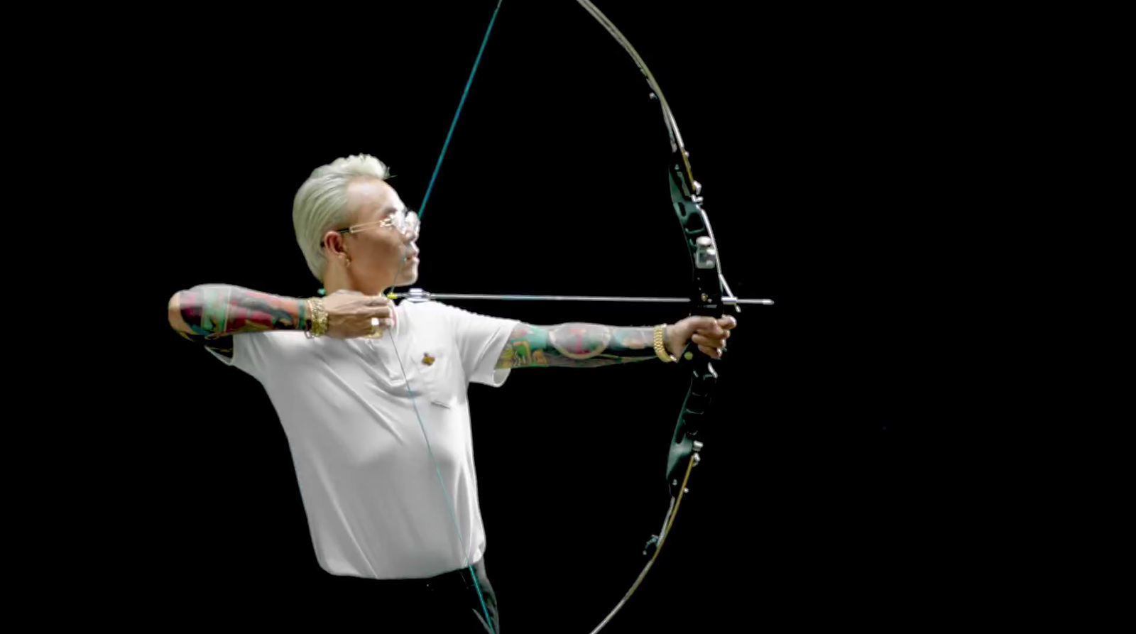 a man in white shirt holding a bow and arrow