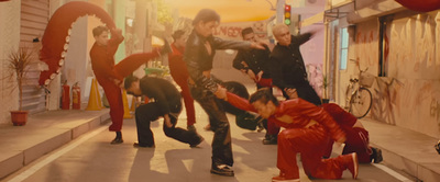 a group of young men dancing on a city street