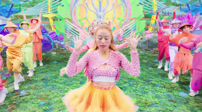 a woman in a pink top and yellow skirt dancing