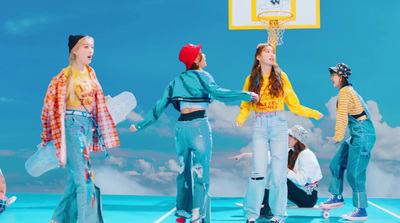 a group of young women standing on top of a basketball court