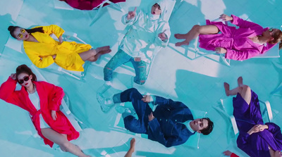 a group of people laying on top of a swimming pool