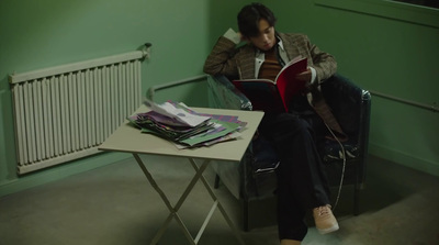 a person sitting on a chair reading a book