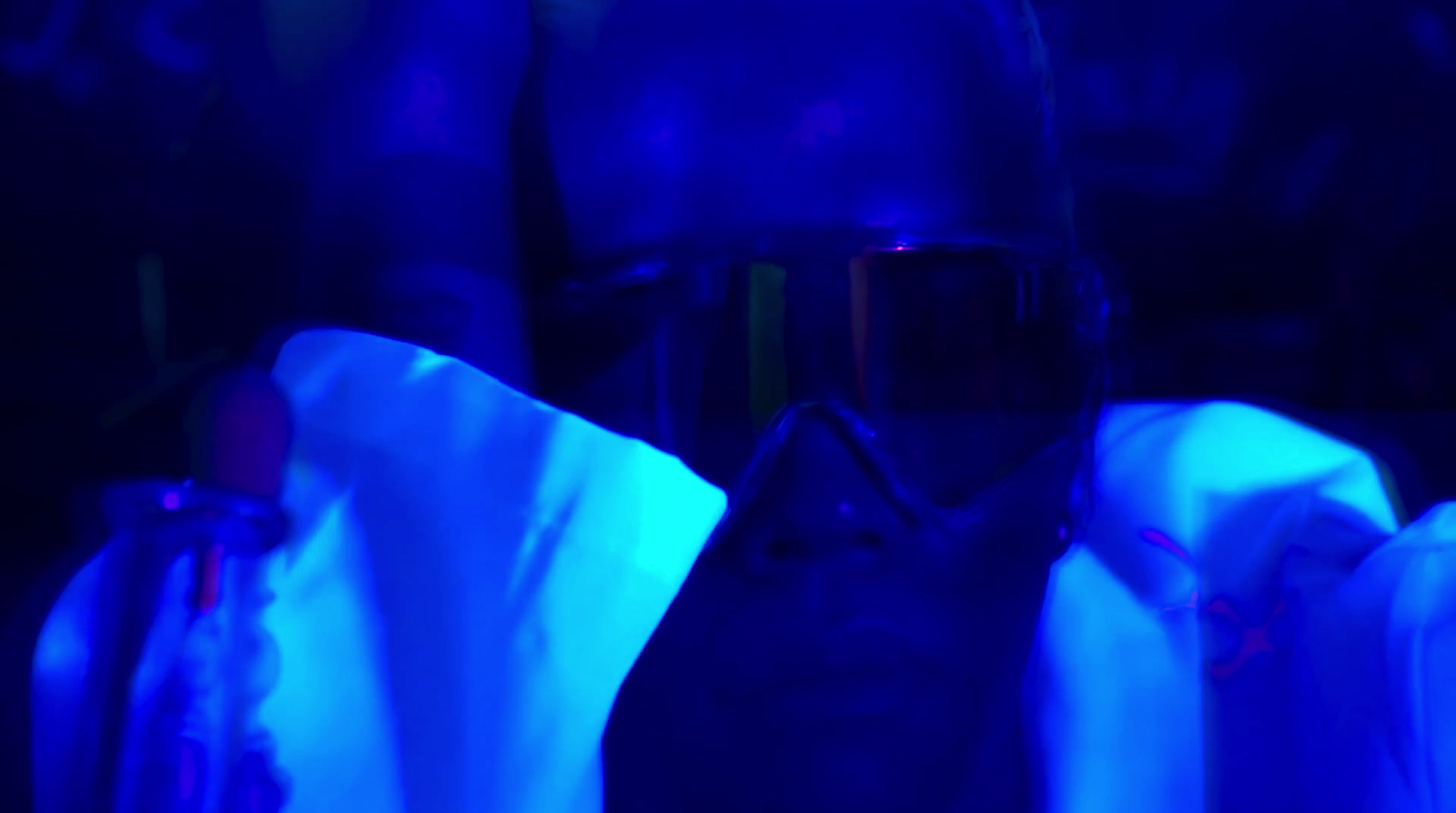 a person in a dark room with a blue light