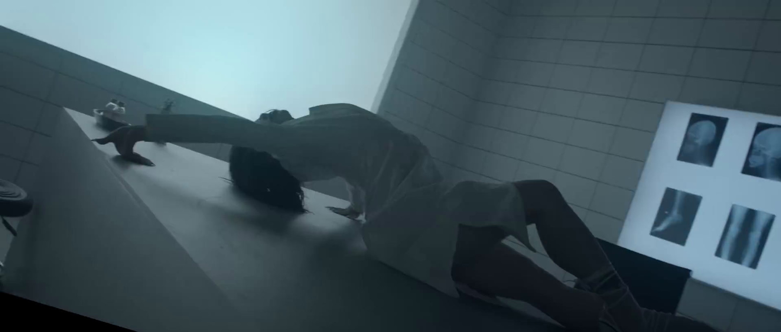 a person laying on a counter in a bathroom