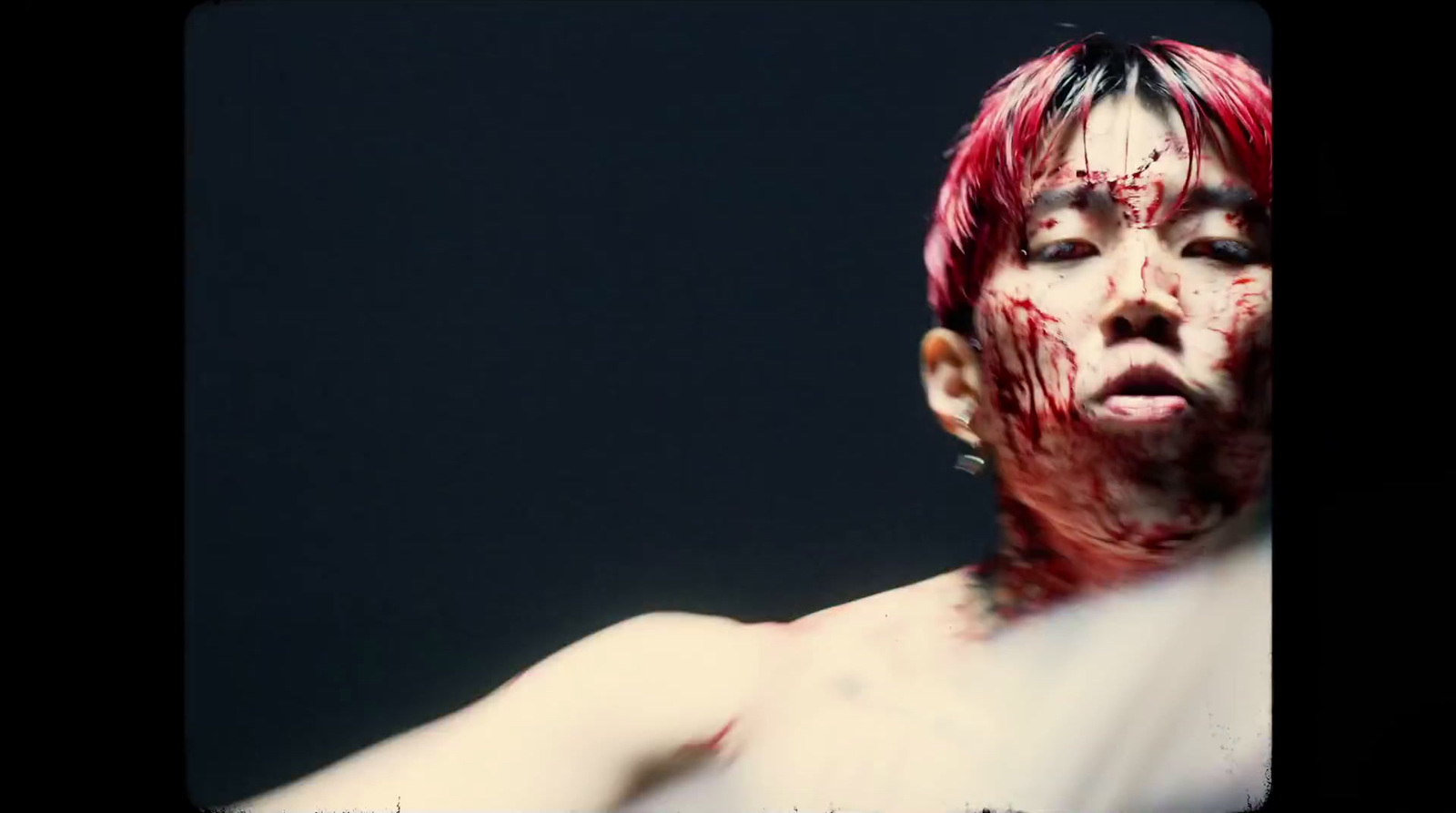 a man with blood all over his face and chest