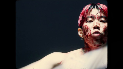 a man with blood all over his face and chest