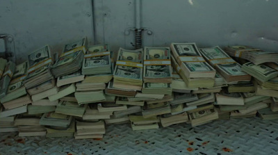 a pile of money sitting on top of a floor