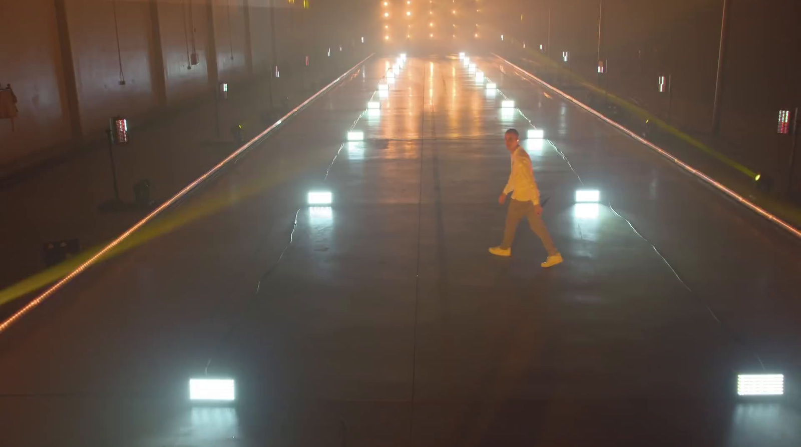 a person walking down a street at night