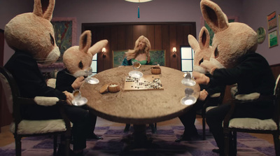 a group of people in bunny ears sitting around a table