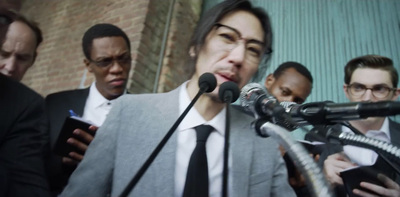 a group of people standing around a microphone