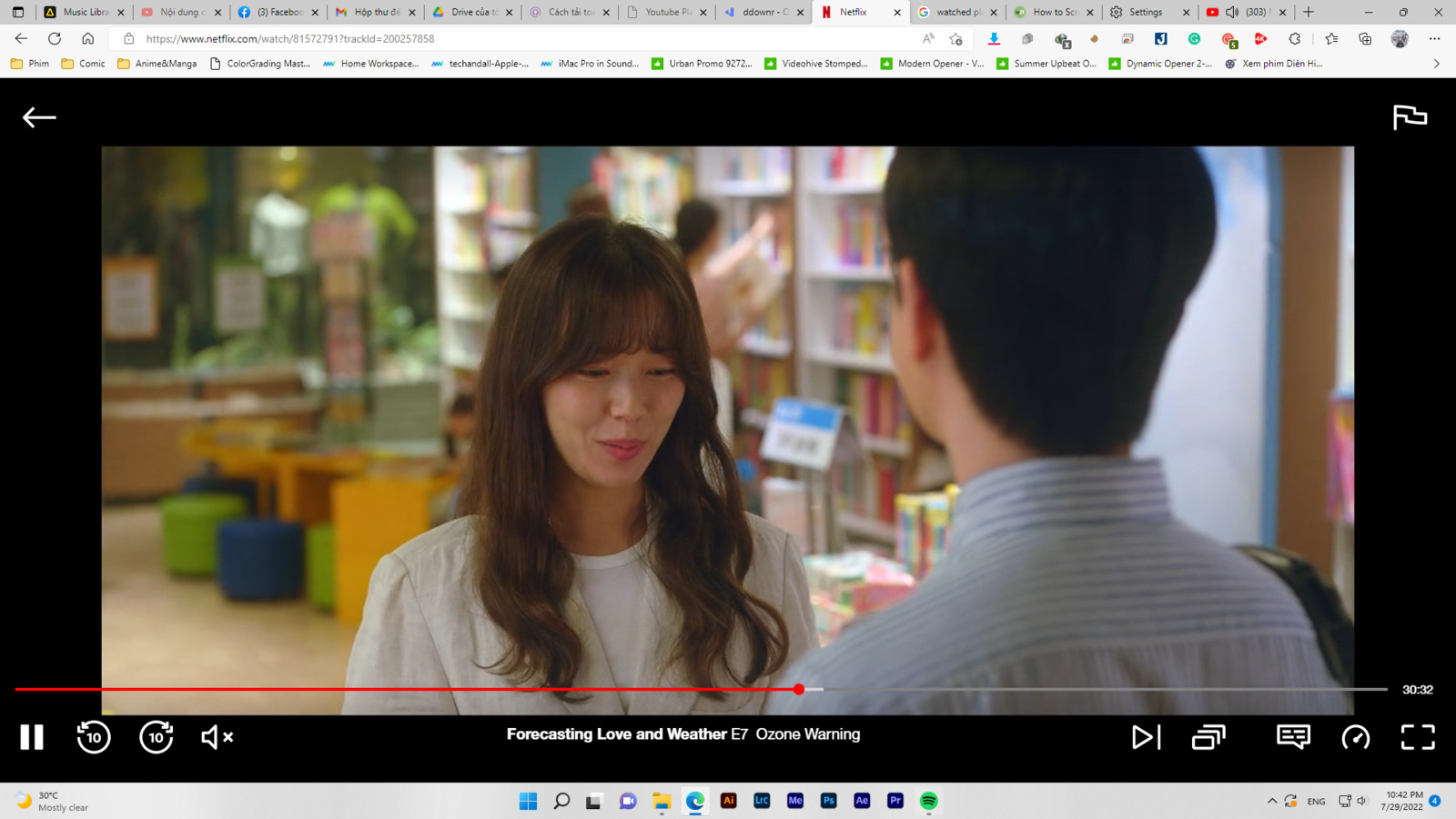 a man and a woman standing in front of a book shelf