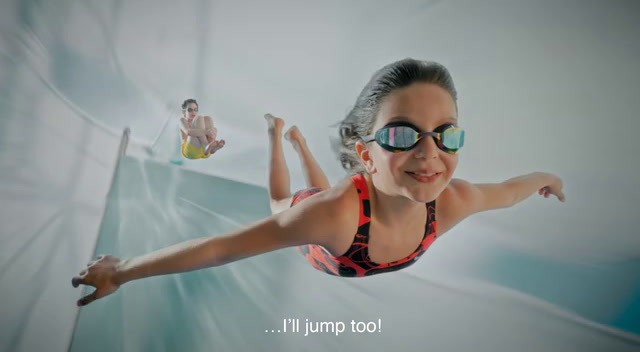 a woman in a red and black swimsuit and goggles