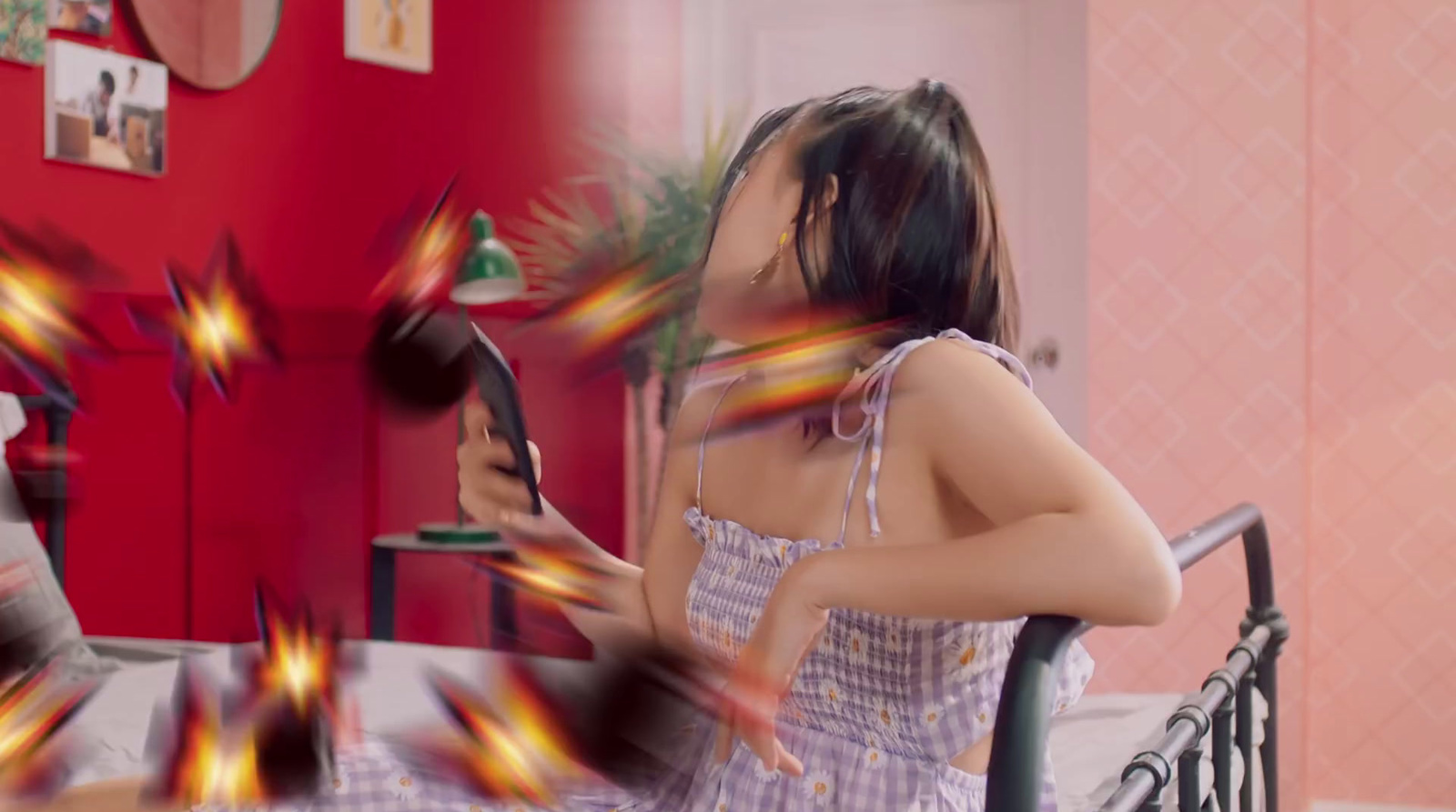 a woman sitting on a chair holding a hair dryer