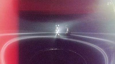 a car driving down a road at night