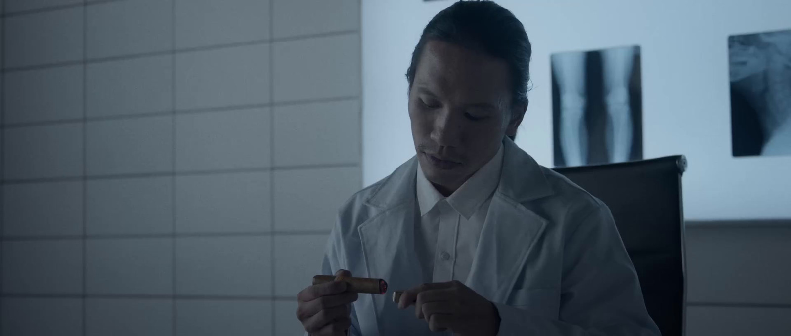 a woman in a white shirt is holding a piece of food