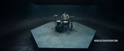 a man is playing drums on a stage