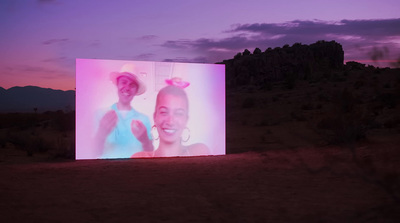 a large screen with a picture of two women on it