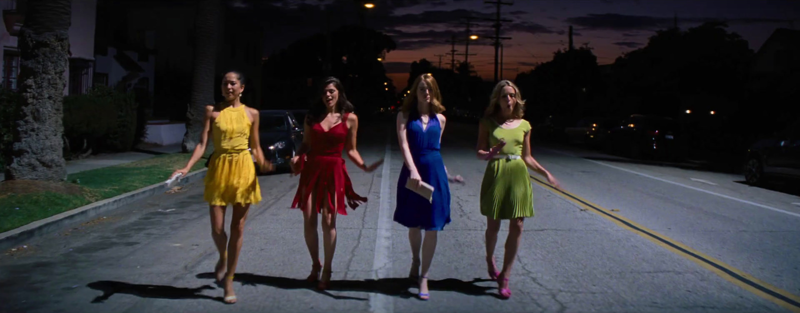 a group of women standing on the side of a road