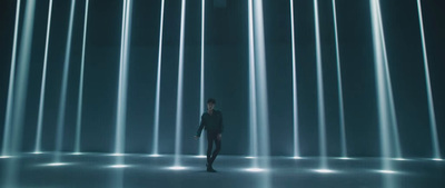 a man standing in front of a wall of lights