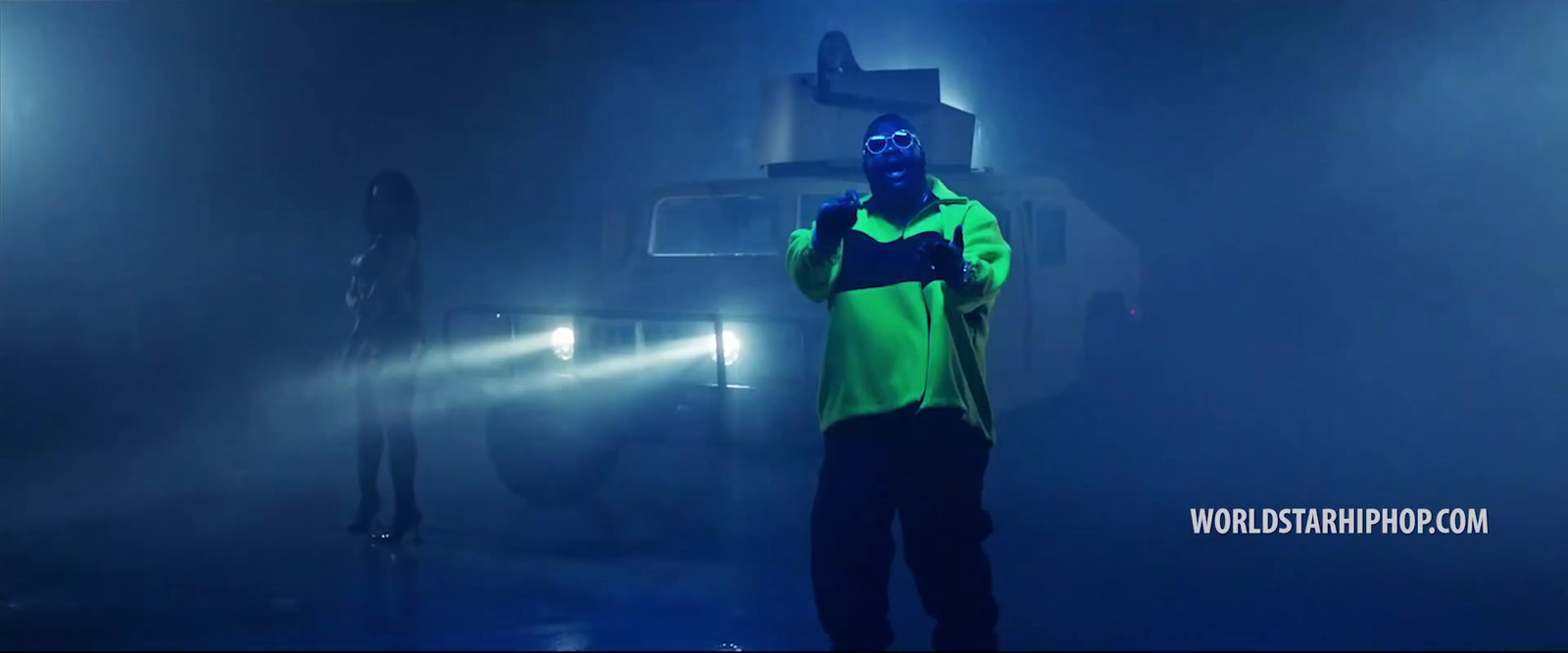 a man standing in front of a truck in the dark