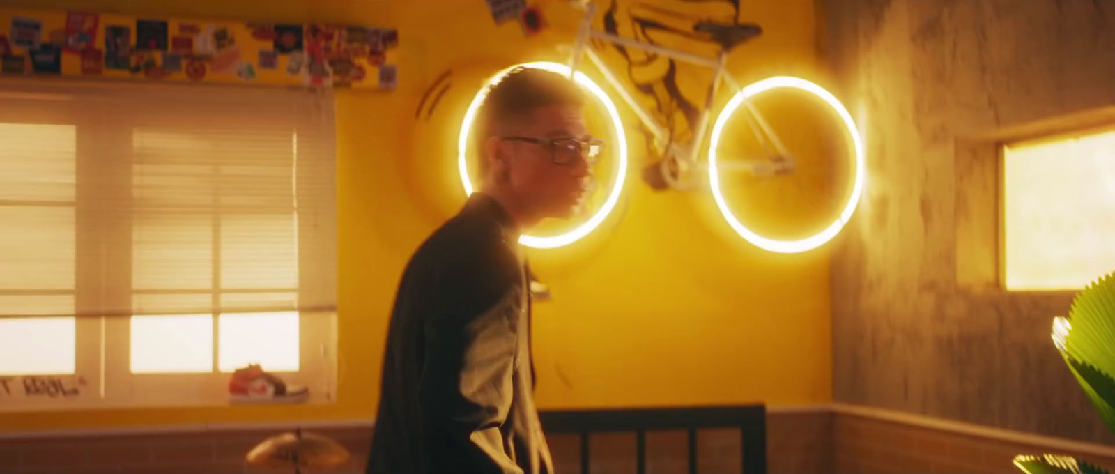 a man standing in a room with a bicycle on the wall