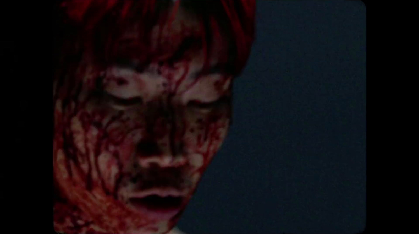 a man with red hair and blood on his face