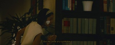a woman standing in front of a book shelf