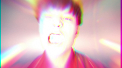 a blurry image of a man with his mouth open