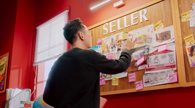 a man standing in front of a bulletin board