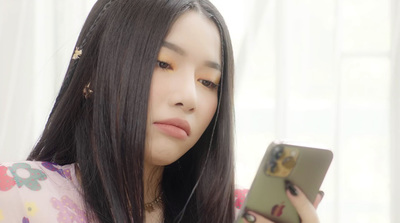 a woman looking at her cell phone in a room